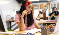 beautiful-mixed-race-female-customer-service-executive-talking-on-headset-and-working-on-laptop.jpg